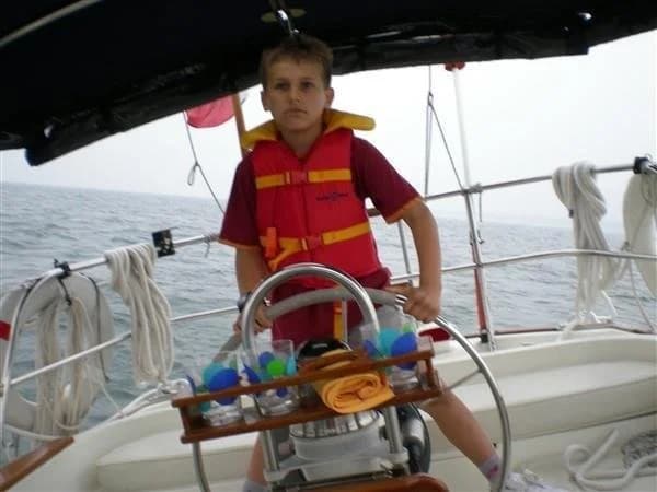 Young James steering the family boat